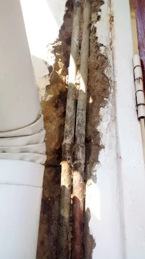 Corroded supply pipes exposed inside an opened wall cavity, burst and leaking pipe cleanup in Brookline, MA